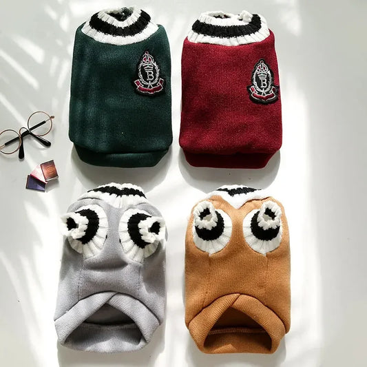 Small dog wearing red knitted pet sweater