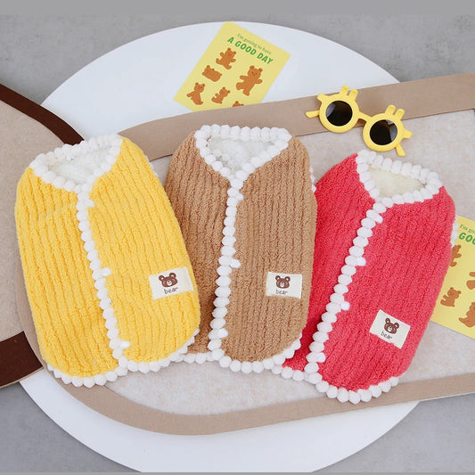 Small dog wearing red fleece winter vest – side view