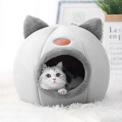 Cat inside cozy cave-style pet bed with ear design