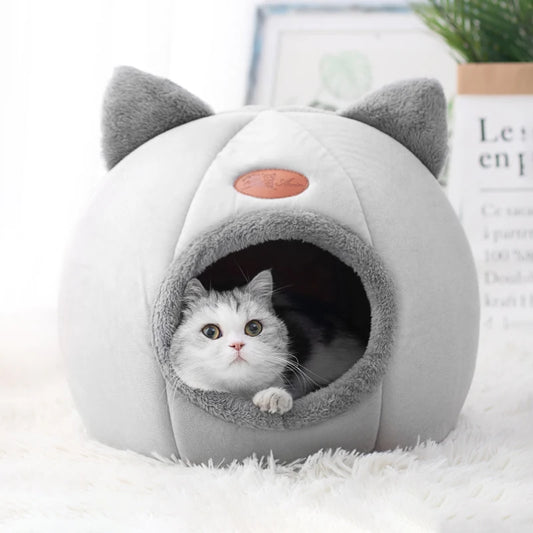 Cat inside cozy cave-style pet bed with ear design