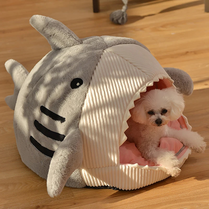 Cute cat relaxing in soft plush shark bed cave