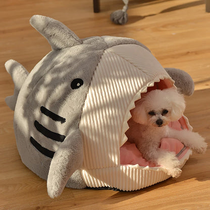 Cute cat relaxing in soft plush shark bed cave