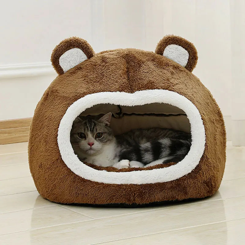 Kitten lounging in warm plush enclosed bed – indoor