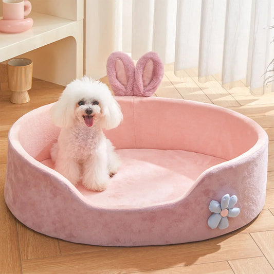 Small dog resting in pink plush pet bed – top view