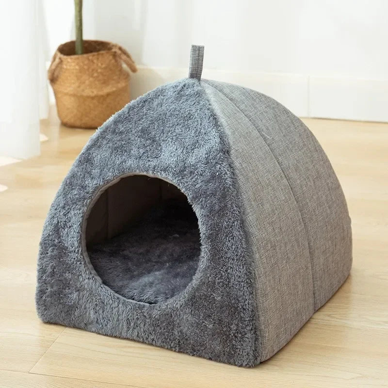 Indoor cat sleeping in cozy warm nest bed