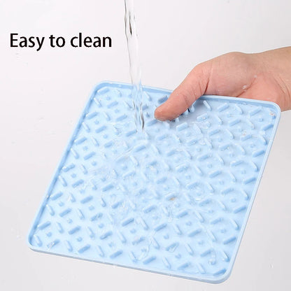 Pink lick mat for dogs with suction cups on the back