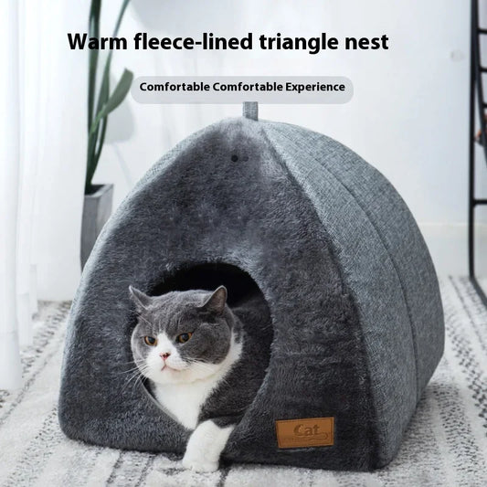Cat resting in triangle-shaped grey nest bed