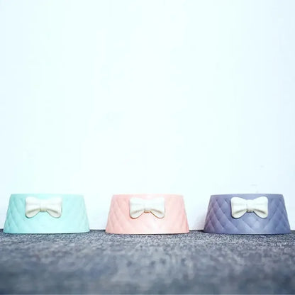 Cat eating from stylish pink bowknot food bowl
