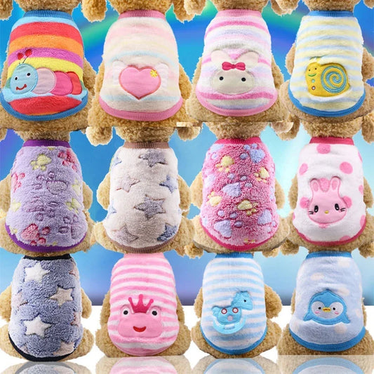 Small dog wearing pink fleece winter clothes
