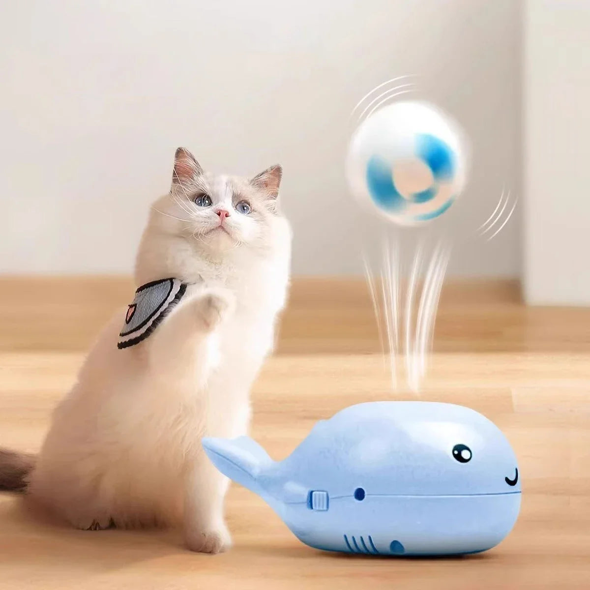 Cat playing with whale-shaped interactive toy – floating ball USB powered