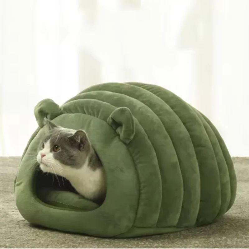 Cat inside green plush cave bed house