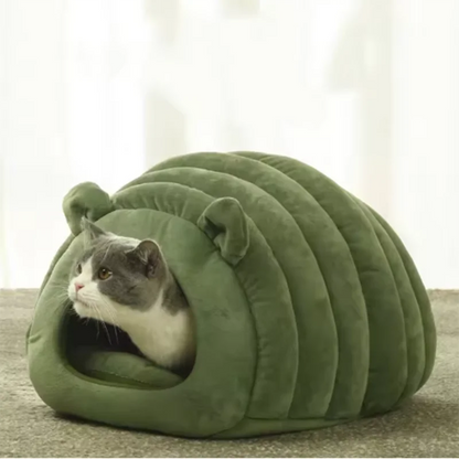 Cat inside green plush cave bed house