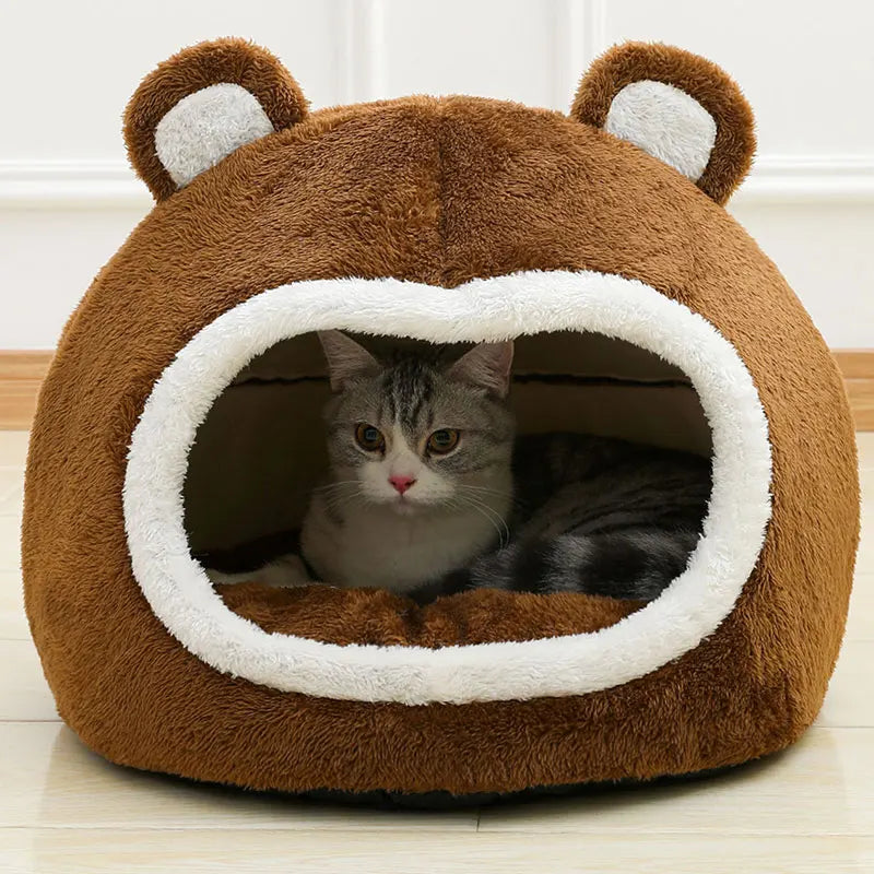Cat inside plush bear-shaped pet bed – front view