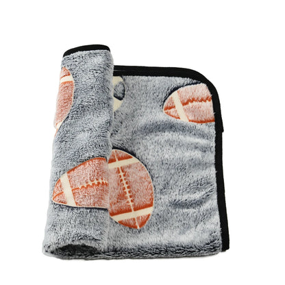 White dog lying on cozy coral fleece blanket