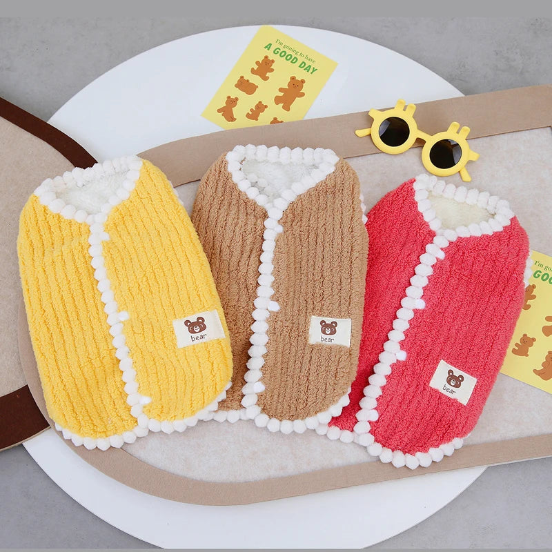 Small dog wearing red fleece winter vest – side view