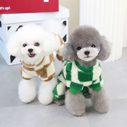 Two dogs wearing matching plaid fleece jumpsuits